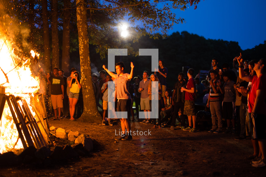 teens gathered around a bonfire 