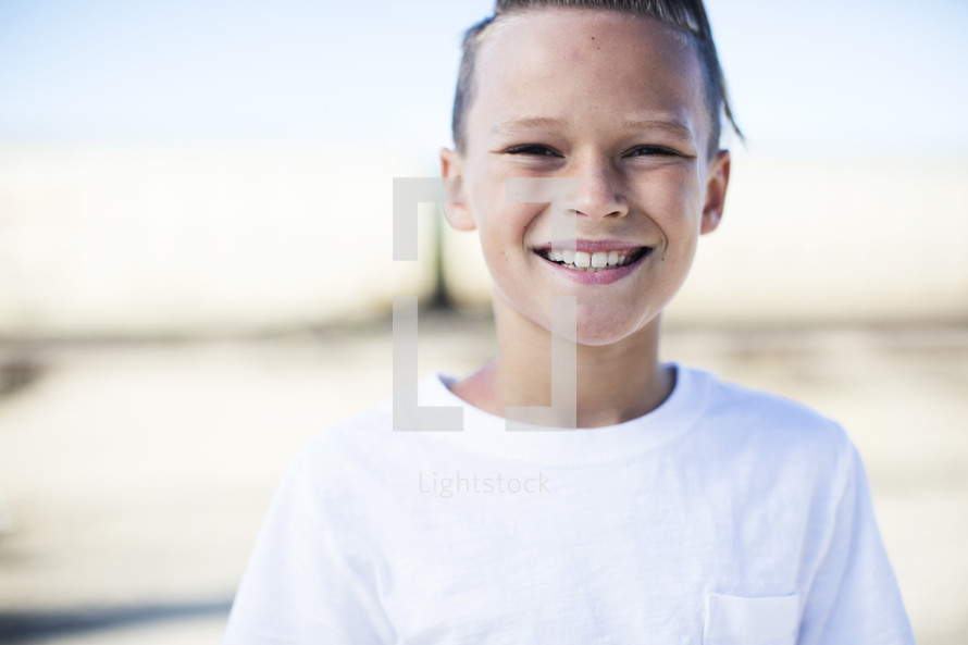 head shot of a smiling preteen boy 