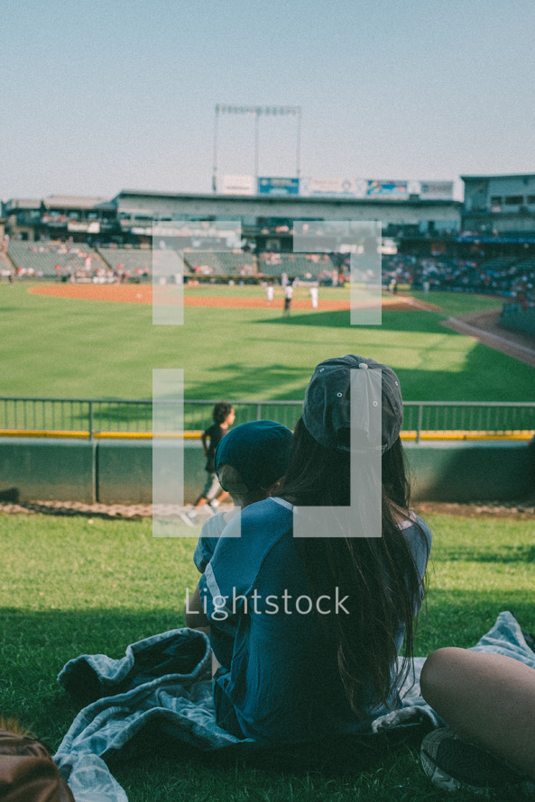 mother and son watching a baseball game 