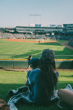 mother and son watching a baseball game 