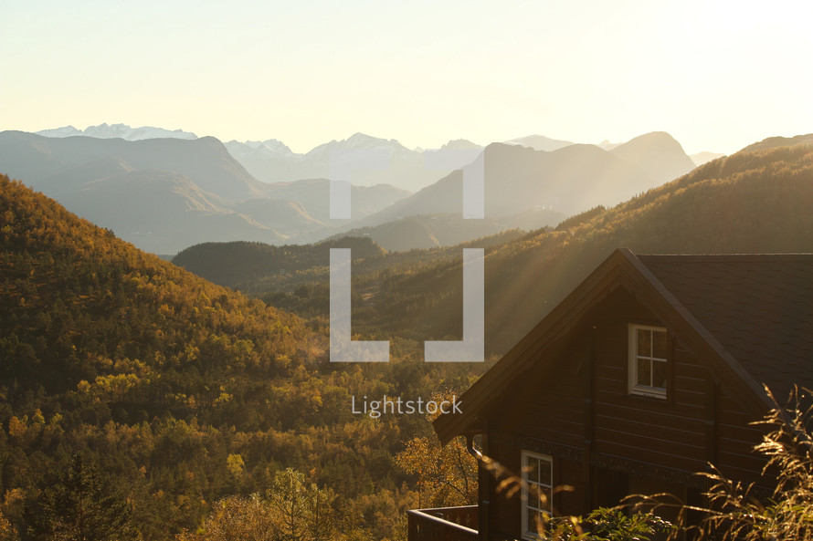 sunlight shining on a mountain cabin 