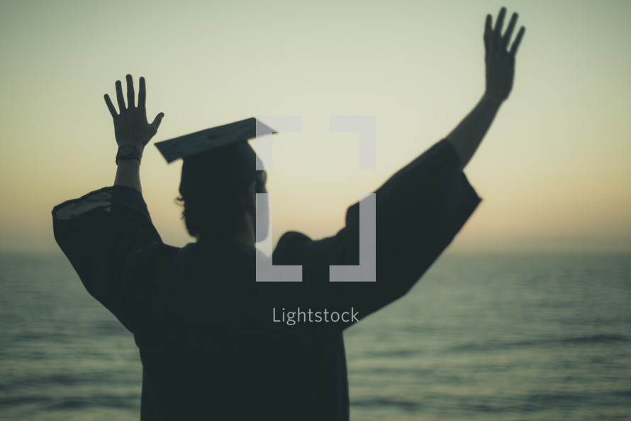 silhouette of a graduate on a beach 