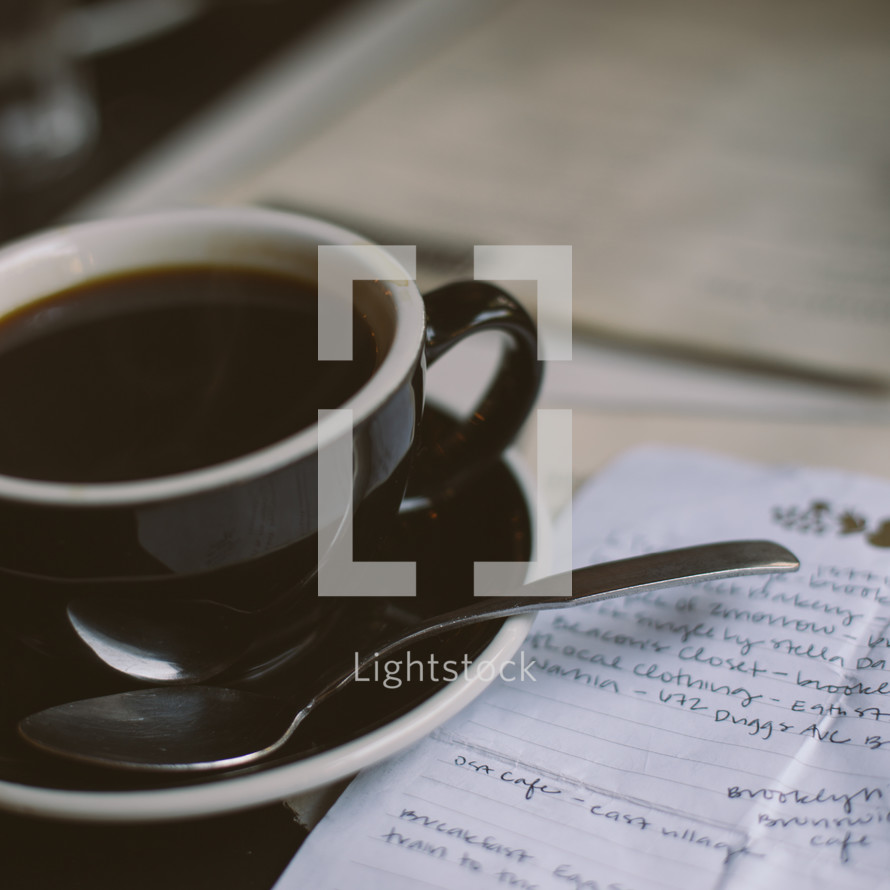 A coffee cup and notes on a to do list 