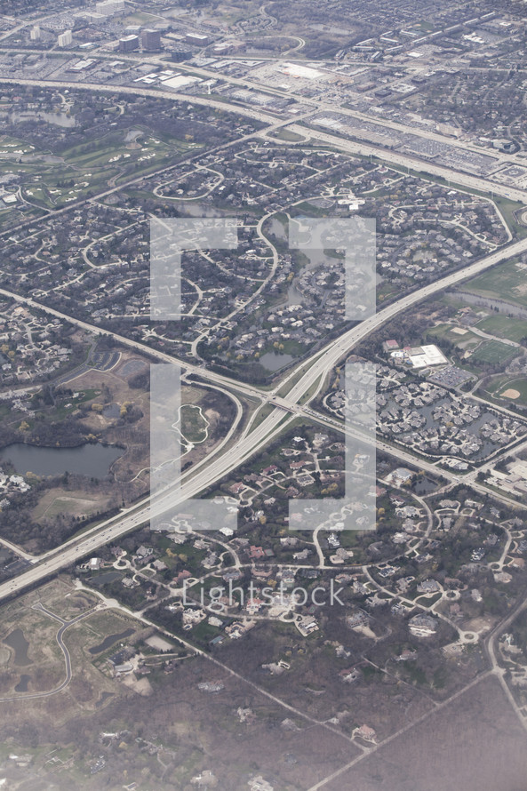 Aerial view of an interstate and surrounding town.