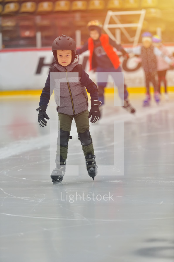 child ice skating with a helmet 
