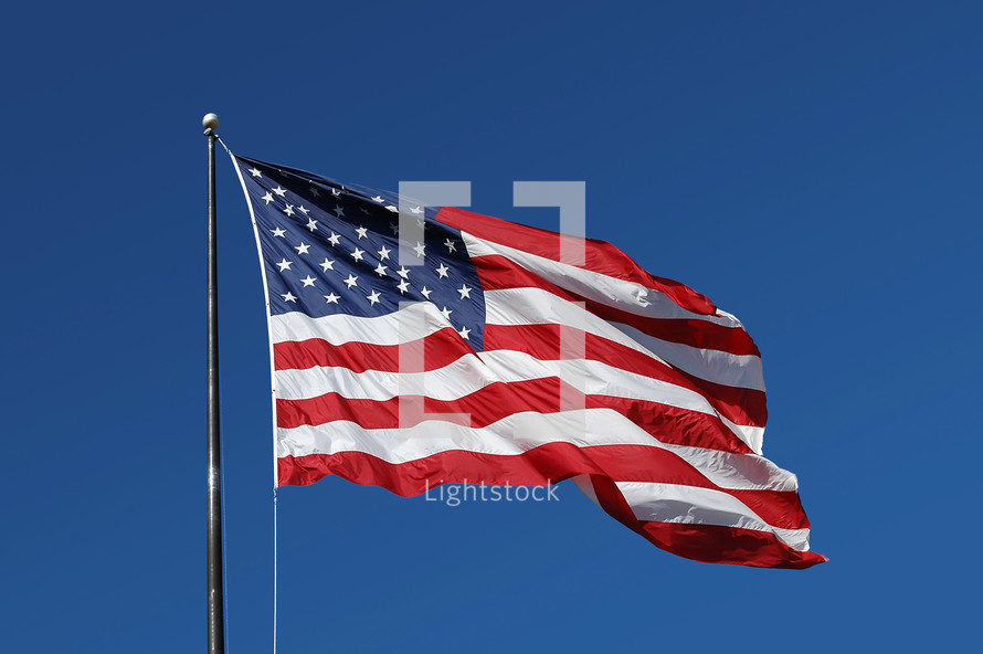 American Flag flying on a flag pole 