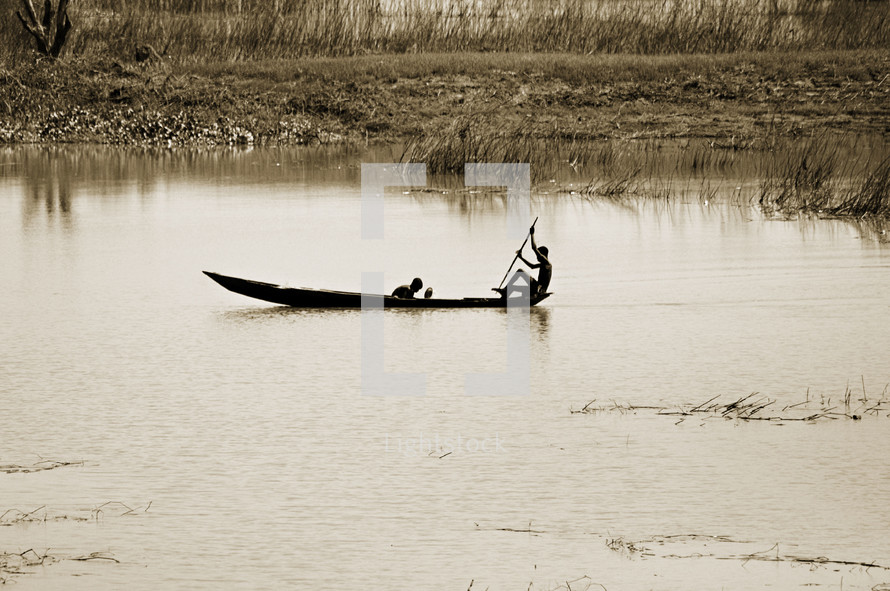 men fishing in a canoe 