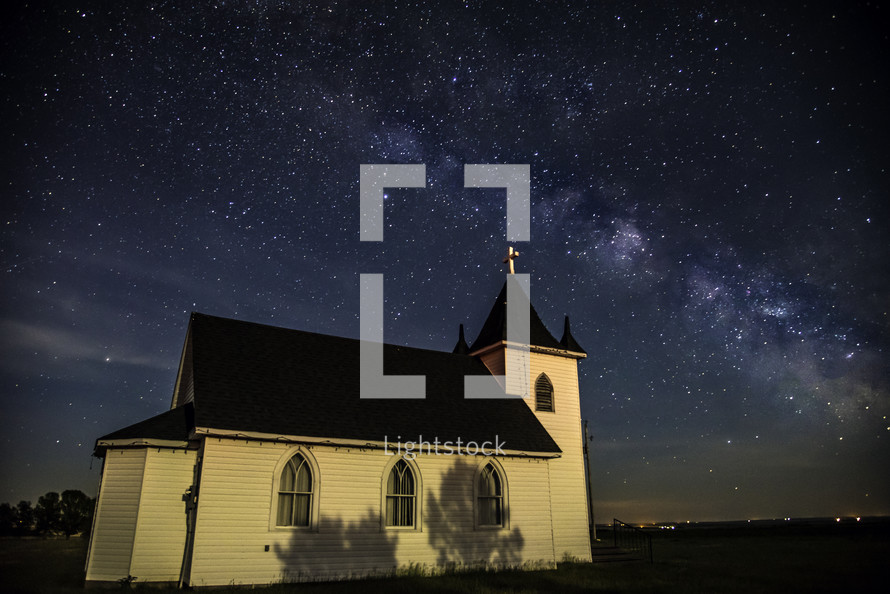 small rural church under stars in the night sky