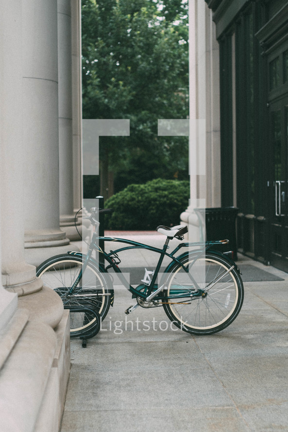 bicycle parked near columns 