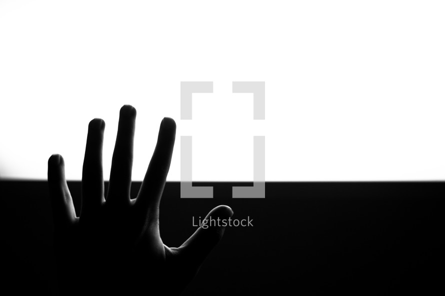 raised hand and black and white background 