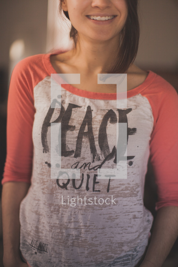 Girl in a T-shirt that says "Peace and quiet"