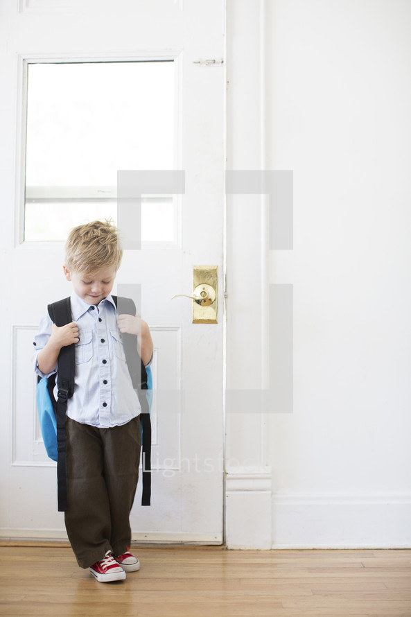 boy child standing at a door - first day of school 