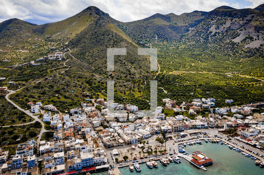 aerial view over a marina in a coastal town 