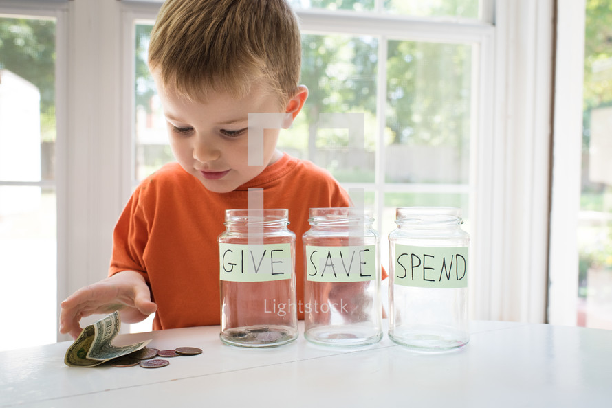 a toddler boy and give, save, spend jars 
