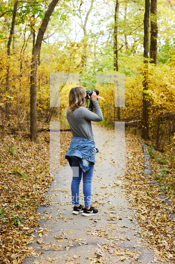 a woman taking a picture with her camera 