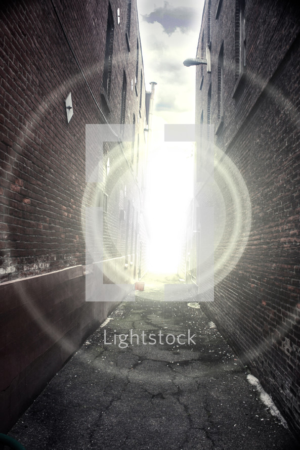 Beam of light in the alley between two buildings.