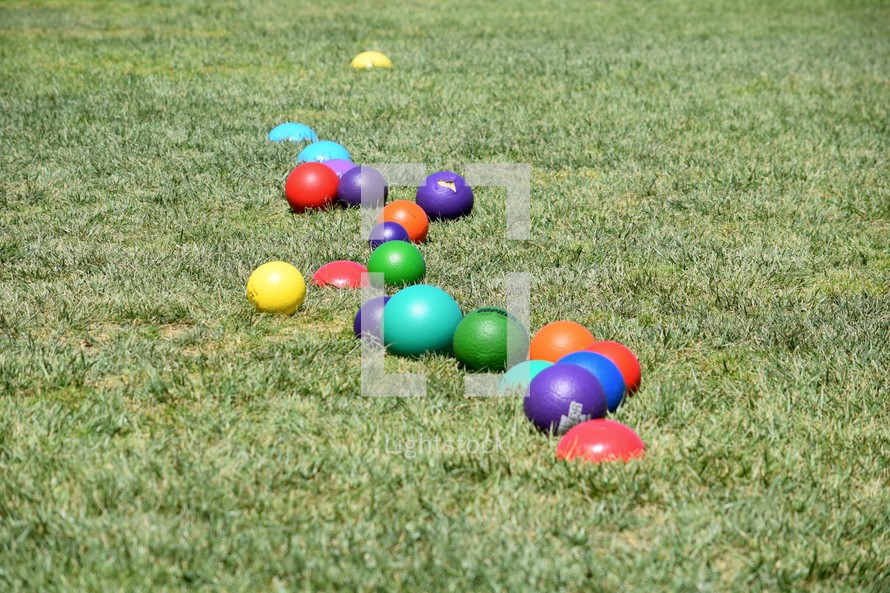 colorful dodgeballs in grass 
