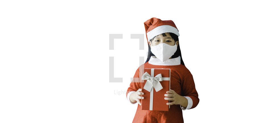 a little girl in a Santa suit holding Christmas gift 