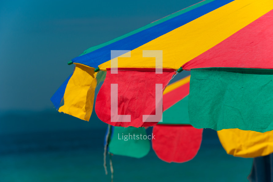Colorful beach umbrella near the ocean.
