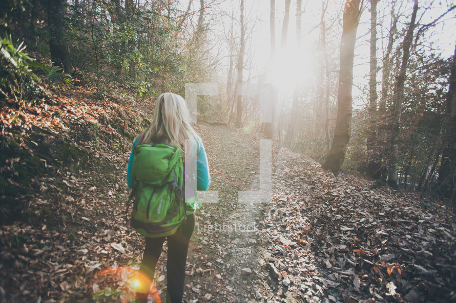 woman backpacking on a nature trail 