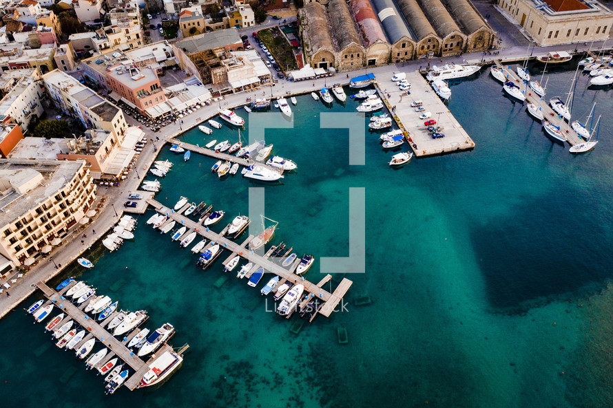 aerial view over a marina in a coastal town 
