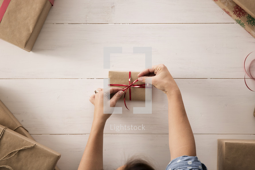 a woman wrapping a gift 