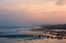 tide washing onto a beach at dusk 