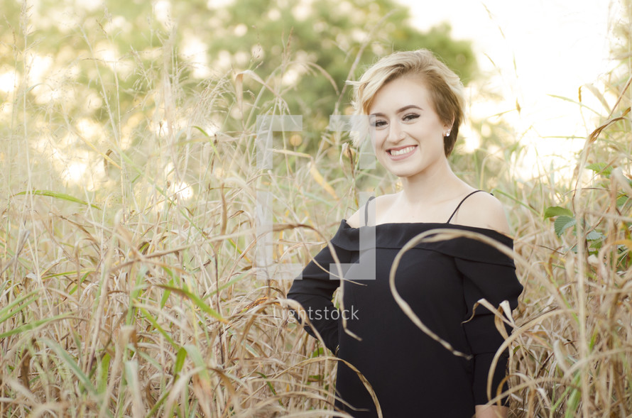 a young woman in a field of tall grasses 