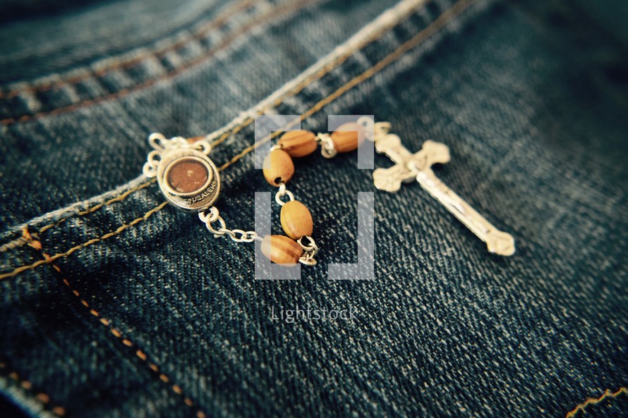 rosary with soil from Jerusalem in a jeans pocket 