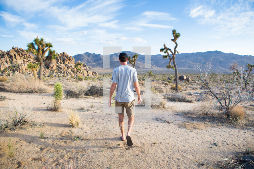 A man walking in a desert.