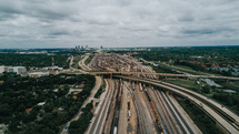 aerial view over highway overpasses and train tracks in a city 