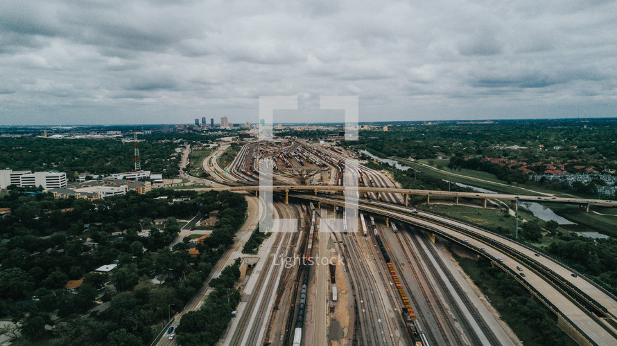 aerial view over highway overpasses and train tracks in a city 