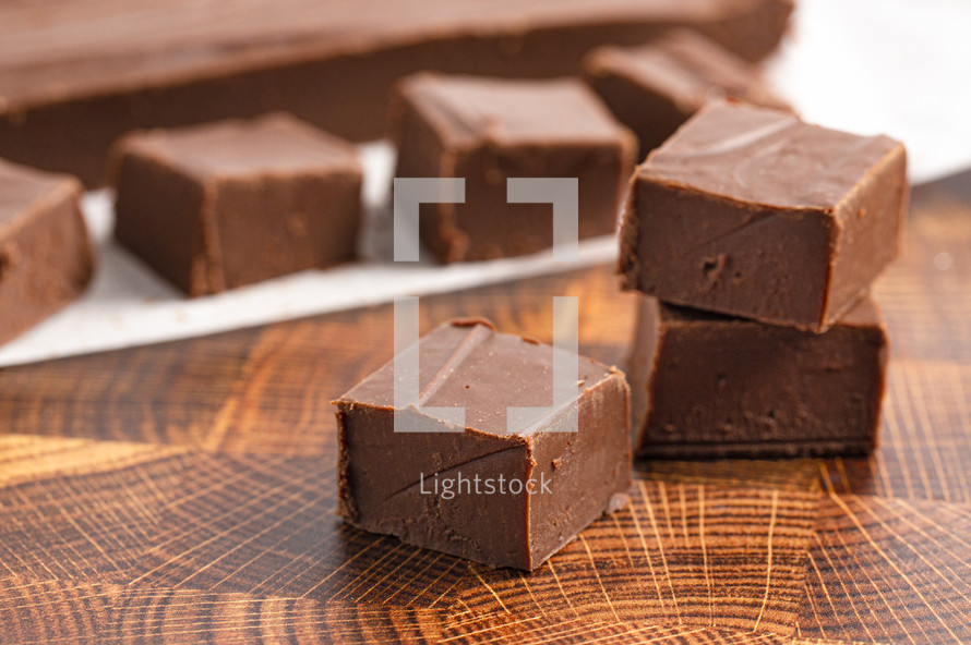 Chocolate fudge squares on a wood table