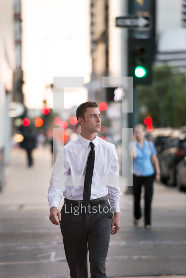 a business man walking down a city street