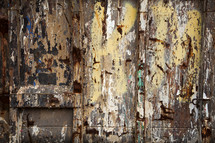 weathered and rusted closeup of the side of a train boxcar