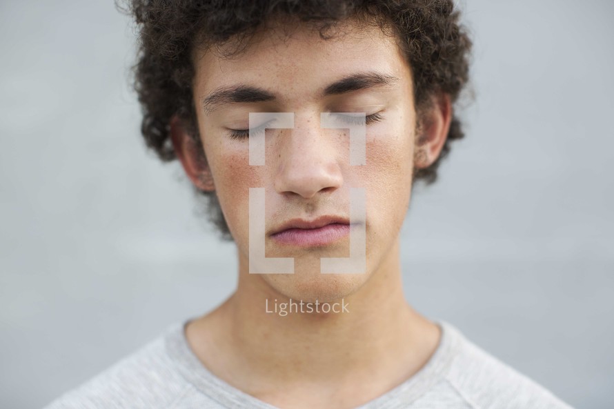 teen boy with closed eyes 