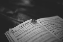 Wedding bands on the pages of a hymnal 