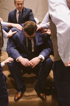 A groom praying before his wedding. 