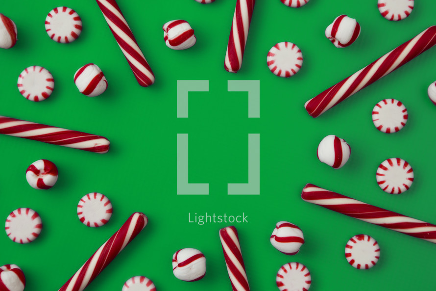 candy canes and mints on green 