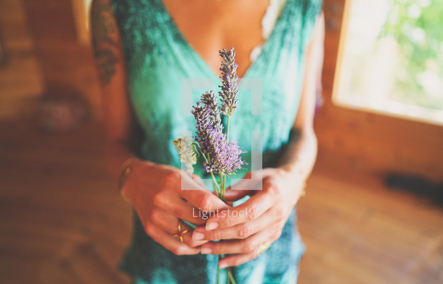 a woman holding lavender flowers 