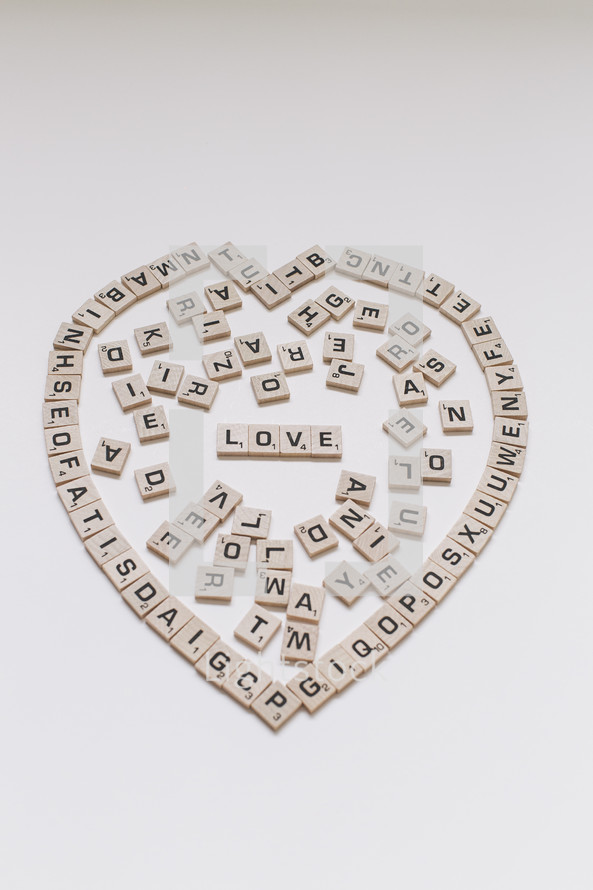 scrabble pieces in the shape of a heart and word love 