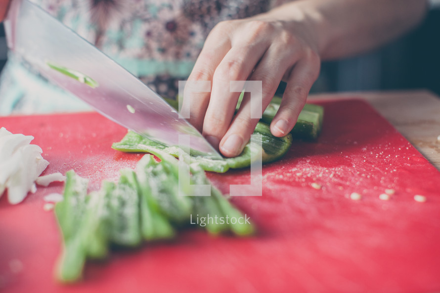 woman chopping peppers