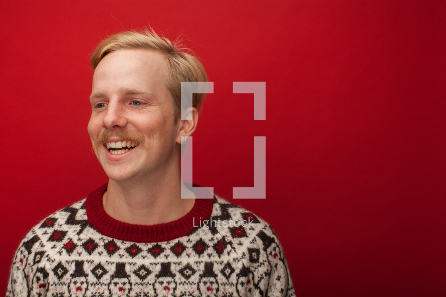 a man with a mustache in Christmas sweater 