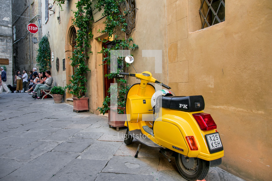 yellow Vespa on the streets of Tuscany
