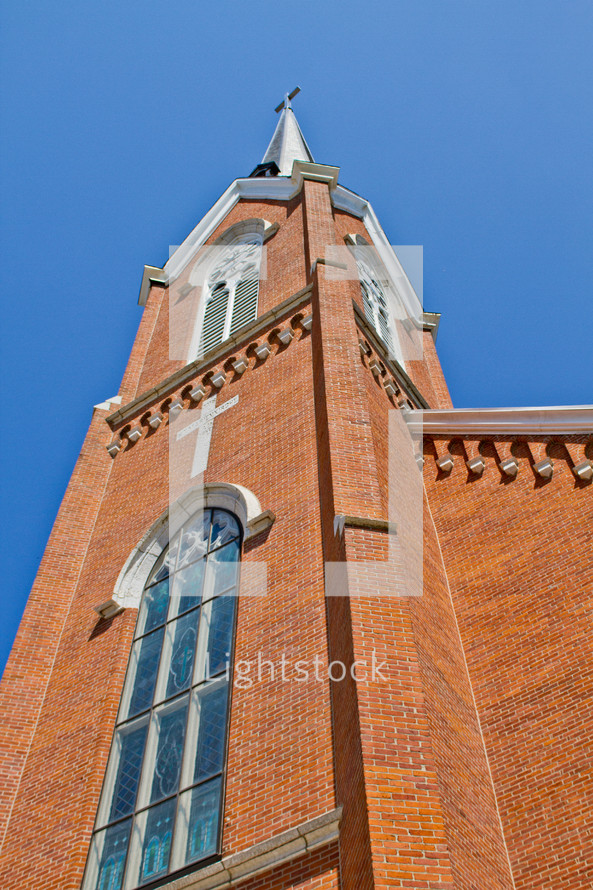 Ground view of a church steeple. 