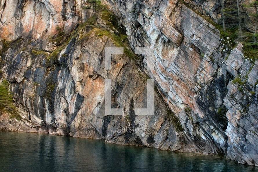 side of a cliff and water 