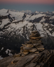 stacked rocks and snow covered peaks 