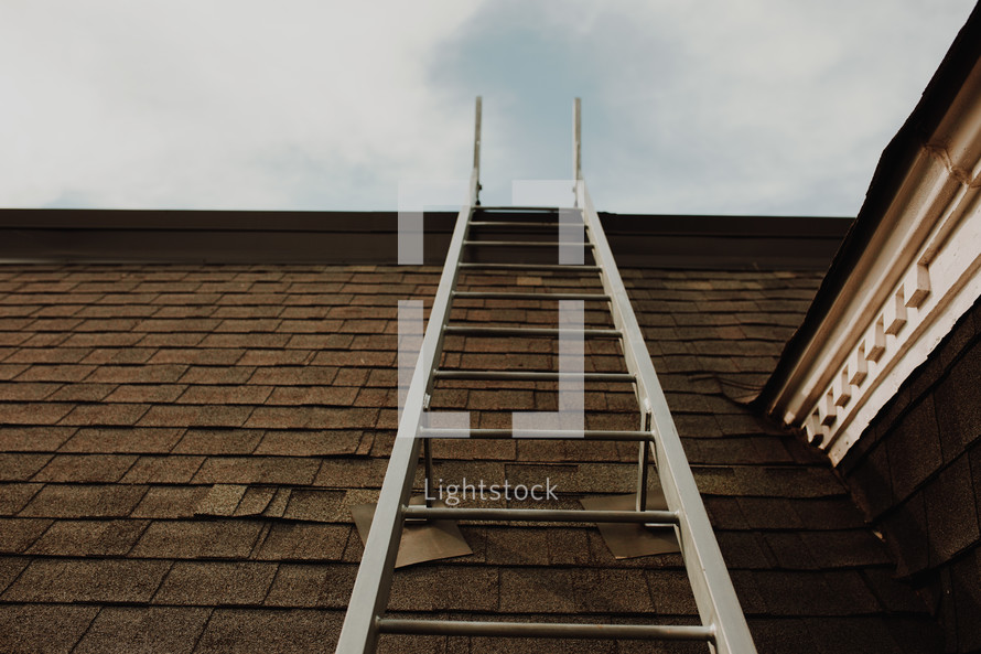 fire escape ladder hanging from a roof 