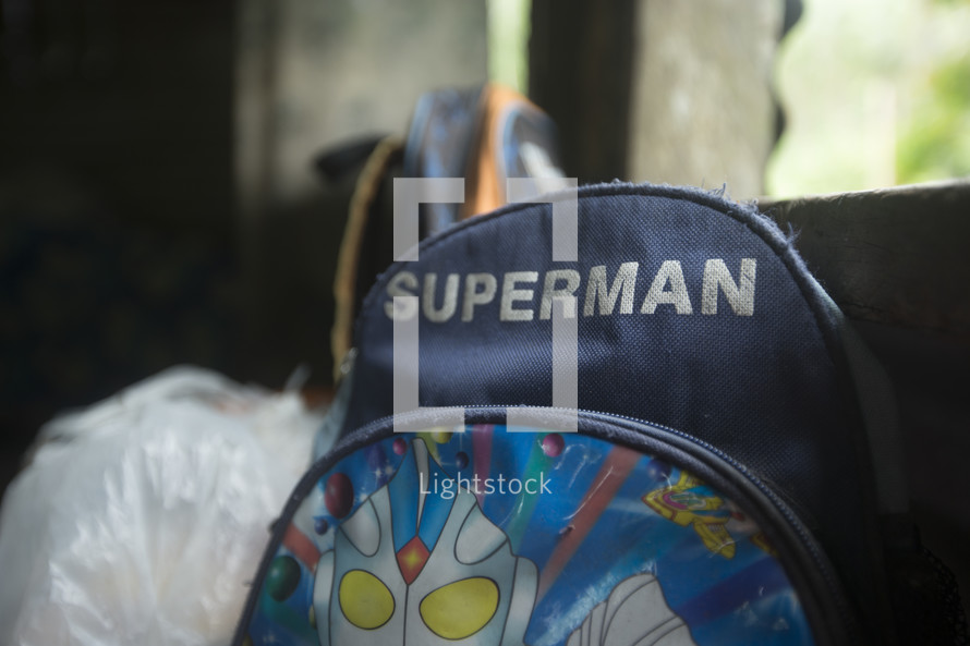 Worn Superman backpack.
