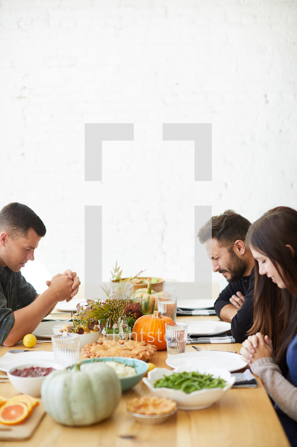praying before Thanksgiving dinner 